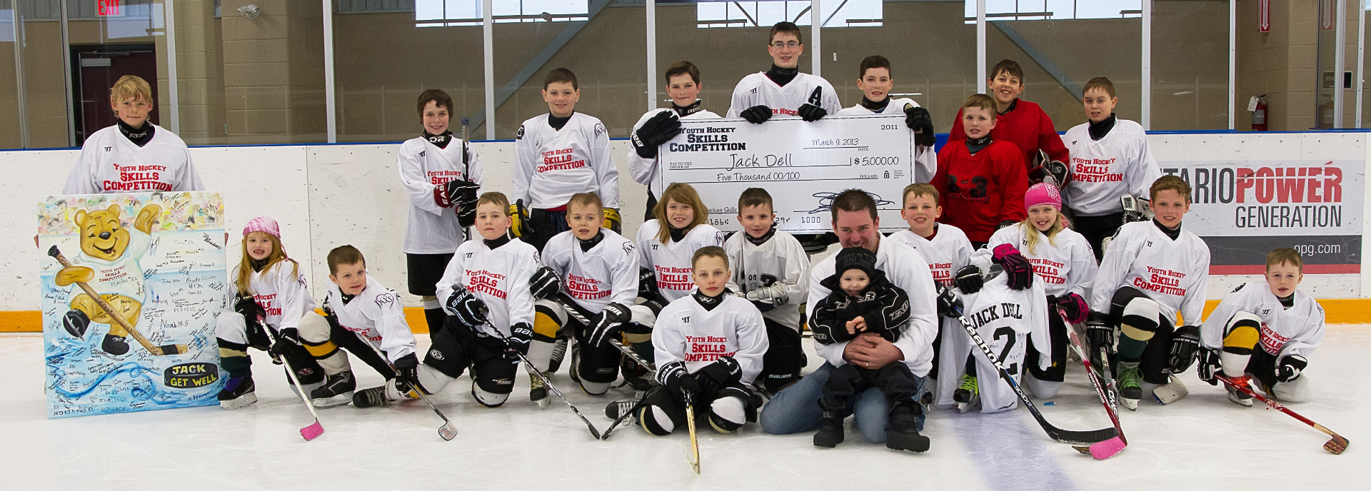 Young players present the $5,000 cheque for Jack Dell at the 2013 Youth Hockey Skills Competition